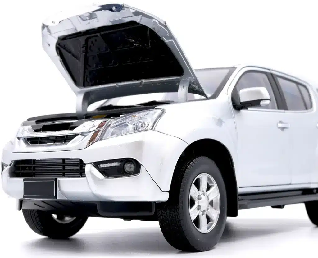 A white SUV with its hood open, revealing the engine compartment. The vehicle is positioned at an angle, showing the front and side, against a plain white background.