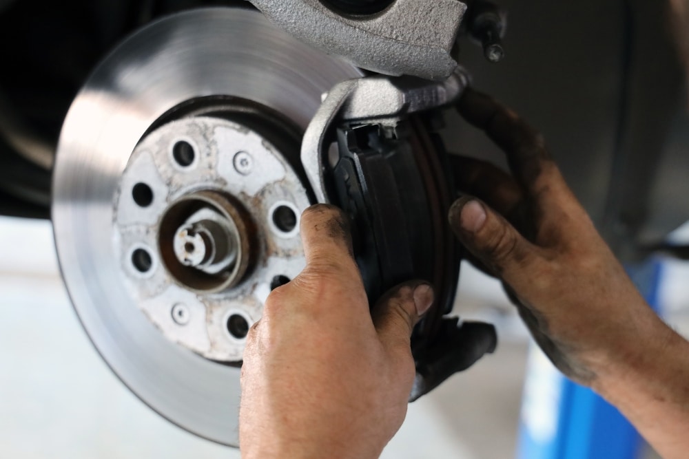 Brakes Checked Before Winter, Brake Repair in St. Charles IL At Fox River Tire & Auto. Close-up view of a vehicle brake system being inspected by a mechanic at an auto repair shop