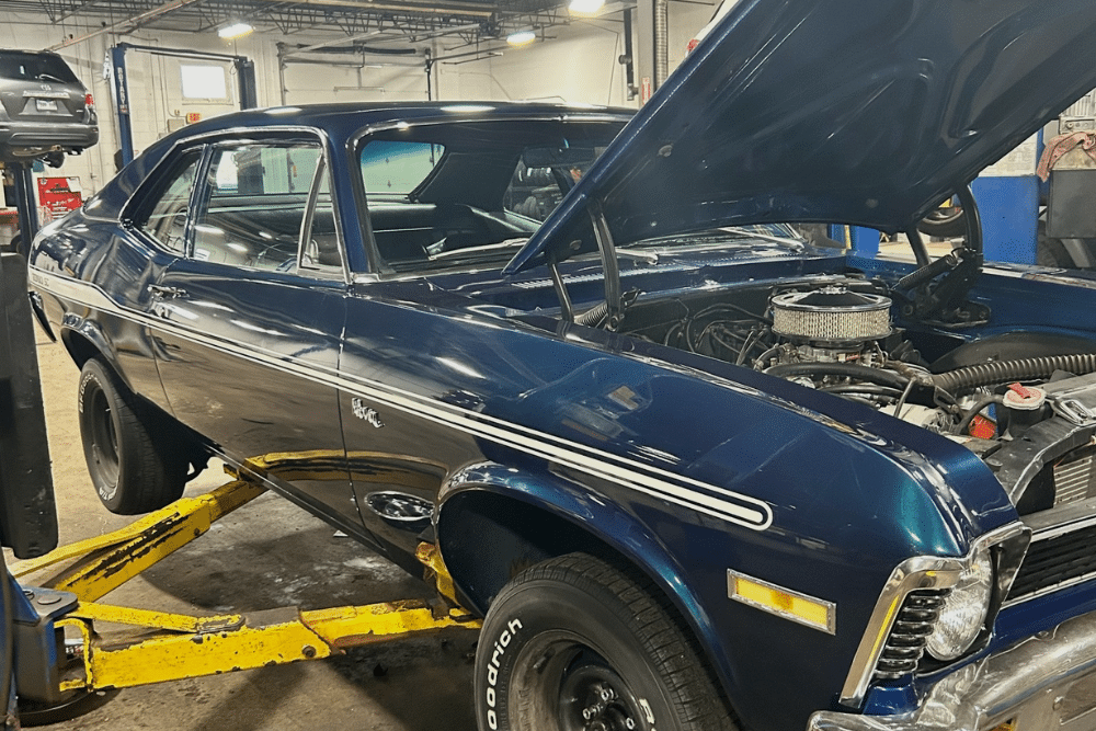 Spring Car Maintenance in St. Charles IL At Fox River Tire & Auto. Image of car being serviced inside an auto repair shop