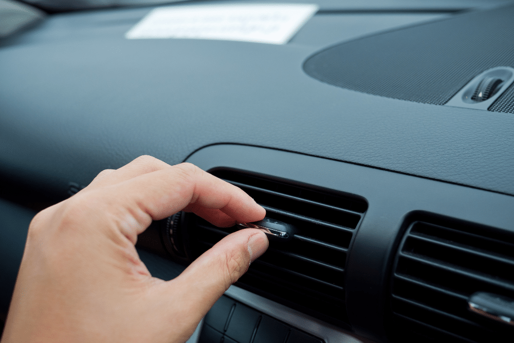 Car Overheating Repair and A/C Service in St. Charles, IL. Person checking weak air conditioning performance inside a vehicle
